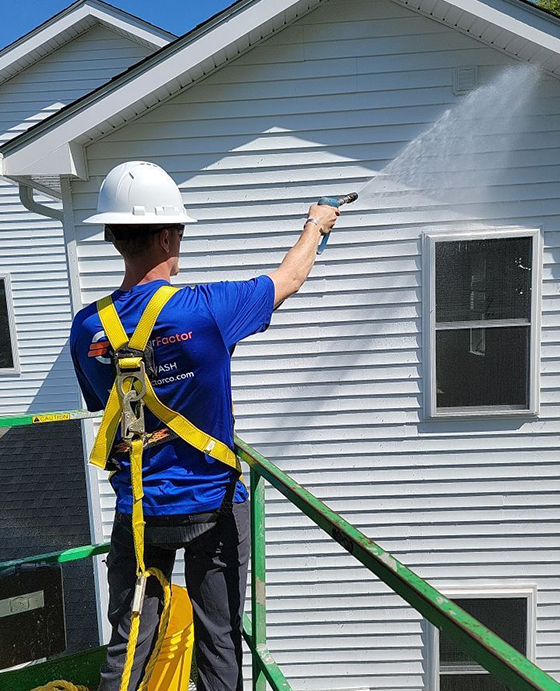 The Clear Factor professional washing siding on white home