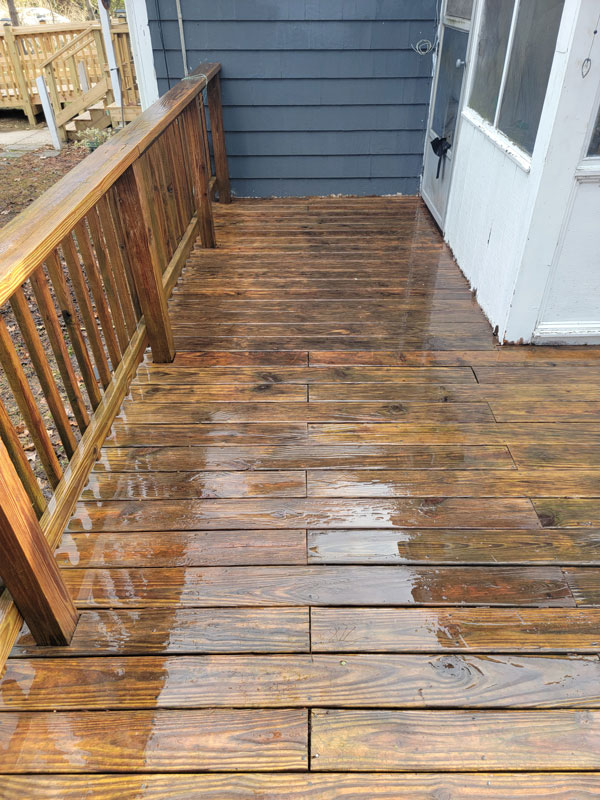 wooden deck after cleaning and restoration on blue home