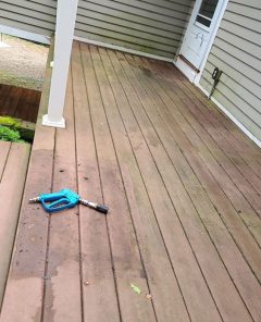 wooden deck on beige home before cleaning